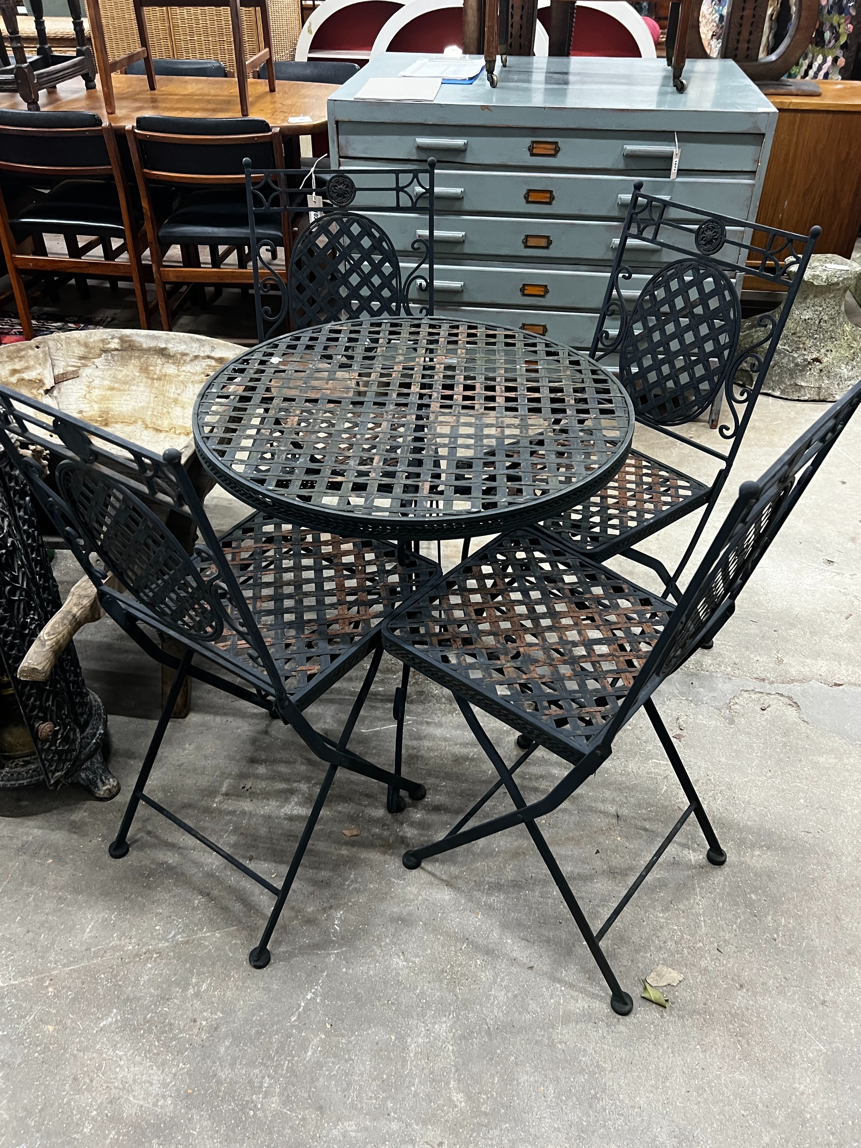 A circular painted metal garden table, diameter 70cm, height 71cm together with four matching folding garden chairs